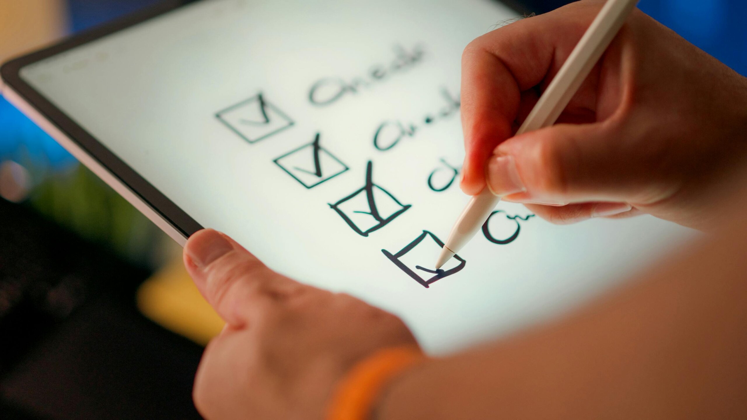Hand checking off items on tablet